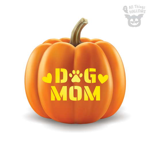 Pumpkin carved with a Dog Mom stencil featuring bold lettering, heart icons, and a paw print for a pet lover themed Halloween jack o' lantern.